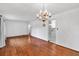 Hardwood floors with chandelier and a view to an adjoining kitchen at 8140 Wood St Se, Covington, GA 30014