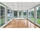 Sunroom featuring hardwood floors, white trimmed windows, and lots of natural light at 8140 Wood St Se, Covington, GA 30014