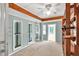 Bright sunroom featuring wood shelving, carpet floor, blue wall, and lots of natural light at 8140 Wood St Se, Covington, GA 30014