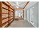 Bright sunroom featuring wood shelving, brick wall, and lots of natural light at 8140 Wood St Se, Covington, GA 30014