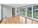 Bright sunroom featuring hardwood floors, blue wall, and lots of natural light at 8140 Wood St Se, Covington, GA 30014