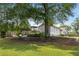 Large backyard featuring a deck, fire pit, mature trees, and lush landscaping at 1450 Walker Se St, Smyrna, GA 30080
