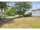 Spacious backyard featuring a charming shed, mature trees, and lush lawn at 1450 Walker Se St, Smyrna, GA 30080