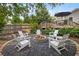 Backyard featuring a fire pit with Adirondack chairs, landscaping, and a deck at 1450 Walker Se St, Smyrna, GA 30080