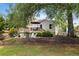 Spacious backyard featuring a deck, fire pit, mature trees, and lush landscaping at 1450 Walker Se St, Smyrna, GA 30080