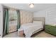 Cozy bedroom featuring floral wallpaper, neutral furniture, and bright natural light at 1450 Walker Se St, Smyrna, GA 30080