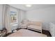 Charming Bedroom with crib, glider chair, pink rug, and lots of natural light at 1450 Walker Se St, Smyrna, GA 30080