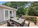 Deck with outdoor table and wicker chairs for dining and lounging under the sun at 1450 Walker Se St, Smyrna, GA 30080