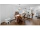 Sunlit dining area with hardwood floors, a round table, and a view of the modern kitchen at 1450 Walker Se St, Smyrna, GA 30080
