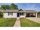 Charming single-story home featuring a well-manicured lawn, a stone walkway and an attached carport at 1450 Walker Se St, Smyrna, GA 30080