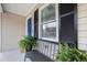 Inviting front porch with bench seating, plants, and a pop of color from the blue door at 1450 Walker Se St, Smyrna, GA 30080