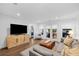 Comfortable living space with a large television, herringbone entertainment center and access to outdoor area at 1450 Walker Se St, Smyrna, GA 30080