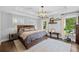 Spacious main bedroom with tray ceiling, light fixtures, and lots of natural light at 1450 Walker Se St, Smyrna, GA 30080