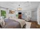 Relaxing main bedroom with tray ceiling, hardwood floors, and a comfortable chair by a window at 1450 Walker Se St, Smyrna, GA 30080