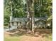 Ranch-style home with a charming front yard surrounded by mature trees at 2058 Pair Sw Rd, Marietta, GA 30008