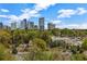 This scenic view showcases the city skyline and lush treetops from a high vantage point at 3235 Roswell Ne Rd # 508, Atlanta, GA 30305