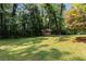 Spacious backyard featuring a shed and mature trees providing ample shade at 553 Collingwood Dr, Decatur, GA 30032