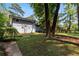 Large backyard with garden beds and a glimpse of the home's exterior at 553 Collingwood Dr, Decatur, GA 30032