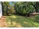 Expansive backyard with lush lawn and mature trees, offering a private outdoor space at 553 Collingwood Dr, Decatur, GA 30032