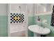 Charming bathroom with pedestal sink, and bath/shower combo at 553 Collingwood Dr, Decatur, GA 30032
