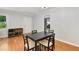 Dining room with a black table, four chairs and hardwood flooring at 553 Collingwood Dr, Decatur, GA 30032
