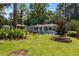 Well-manicured lawn, accented by thoughtfully arranged plantings and landscaping, creates curb appeal at 553 Collingwood Dr, Decatur, GA 30032
