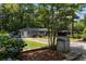 Charming home exterior with lush hydrangeas and a well-manicured front lawn at 553 Collingwood Dr, Decatur, GA 30032