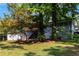 Well-maintained front yard with mature trees and attractive landscaping around the home at 553 Collingwood Dr, Decatur, GA 30032