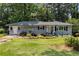 Well-maintained single-story home with gray paint and front yard landscaping at 553 Collingwood Dr, Decatur, GA 30032