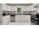 Bright eat in kitchen with white cabinets, stainless steel appliances and gray counter tops at 553 Collingwood Dr, Decatur, GA 30032