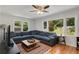 Bright living room featuring hardwood floors, large windows and a comfortable sectional sofa at 553 Collingwood Dr, Decatur, GA 30032