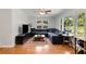 Cozy living room with hardwood floors, large windows, and a comfortable sectional sofa at 553 Collingwood Dr, Decatur, GA 30032