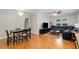 Open-concept living space featuring hardwood floors, a dining area, and a comfortable seating area at 553 Collingwood Dr, Decatur, GA 30032