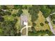 Aerial view of a sprawling property featuring a well-maintained lawn, mature trees, and a private driveway leading to the home at 100 Marshas Vineyard, Hampton, GA 30228