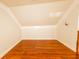 Finished attic space with hardwood floors, a window, and neutral walls at 100 Marshas Vineyard, Hampton, GA 30228