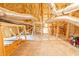 Spacious unfinished attic with wooden beams, insulation, and carpeted floor with storage or expansion potential at 100 Marshas Vineyard, Hampton, GA 30228