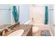 Bathroom with shower and vanity, complete with a blue shower curtain at 100 Marshas Vineyard, Hampton, GA 30228