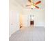 Bedroom with neutral walls, plush carpet, bathroom access, and a modern ceiling fan at 100 Marshas Vineyard, Hampton, GA 30228