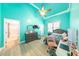 Light-filled bedroom boasts wood floors, a ceiling fan, and en-suite bathroom at 100 Marshas Vineyard, Hampton, GA 30228