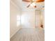 Bright bedroom features ceiling fan, neutral walls, plush carpeting, and natural light from the window at 100 Marshas Vineyard, Hampton, GA 30228