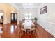 Elegant dining area boasts beautiful hardwood floors, sophisticated decor, and arched entryways at 100 Marshas Vineyard, Hampton, GA 30228