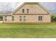 Side view of brick home with access to the back porch with multiple windows and doors at 100 Marshas Vineyard, Hampton, GA 30228