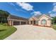 A stunning brick home with a three-car garage and spacious concrete driveway at 100 Marshas Vineyard, Hampton, GA 30228