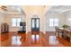 Open concept view of foyer, living room, and dining area showcasing hardwood floors and natural light at 100 Marshas Vineyard, Hampton, GA 30228