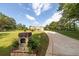 Long paved driveway leading to a house on a manicured lot at 100 Marshas Vineyard, Hampton, GA 30228