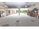 Spacious garage with high ceilings, multiple bays, and ample storage, offering convenience and functionality at 100 Marshas Vineyard, Hampton, GA 30228