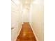 Hallway features wood floors, white walls, and a vaulted ceiling at 100 Marshas Vineyard, Hampton, GA 30228