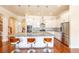 Well-appointed kitchen with a large island, stainless steel appliances, and hardwood floors at 100 Marshas Vineyard, Hampton, GA 30228