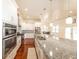 Bright kitchen with white cabinets, granite counters, stainless appliances and eat-in breakfast area at 100 Marshas Vineyard, Hampton, GA 30228