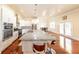 Open kitchen with granite countertops, stainless steel appliances, and a large island at 100 Marshas Vineyard, Hampton, GA 30228